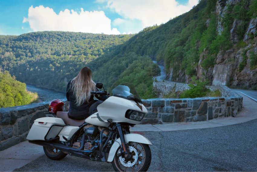 Jess with motorcycle overlooking the mountainside